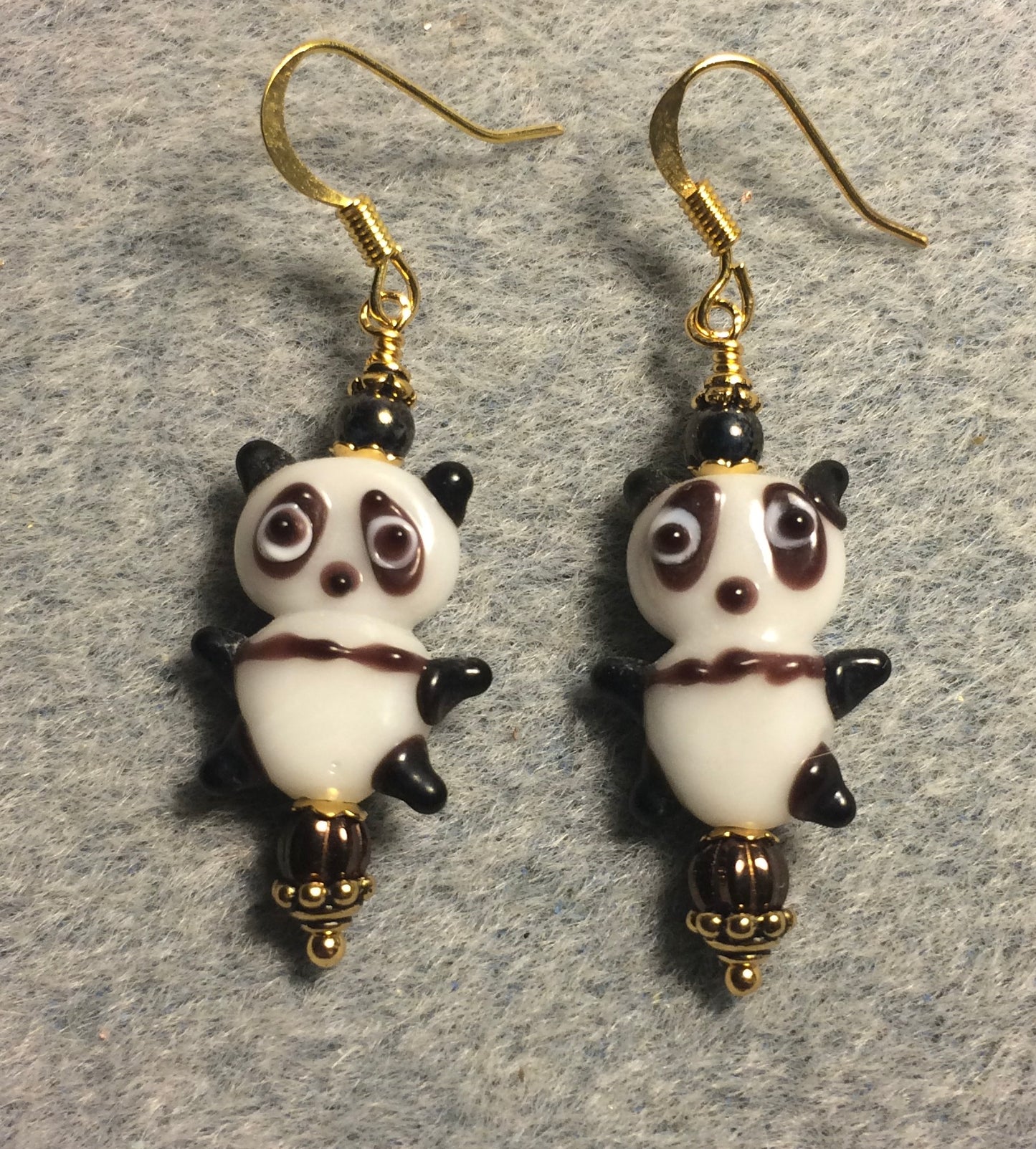 Small brown and white lamp work panda bear bead earrings adorned with brown Chinese crystal beads.