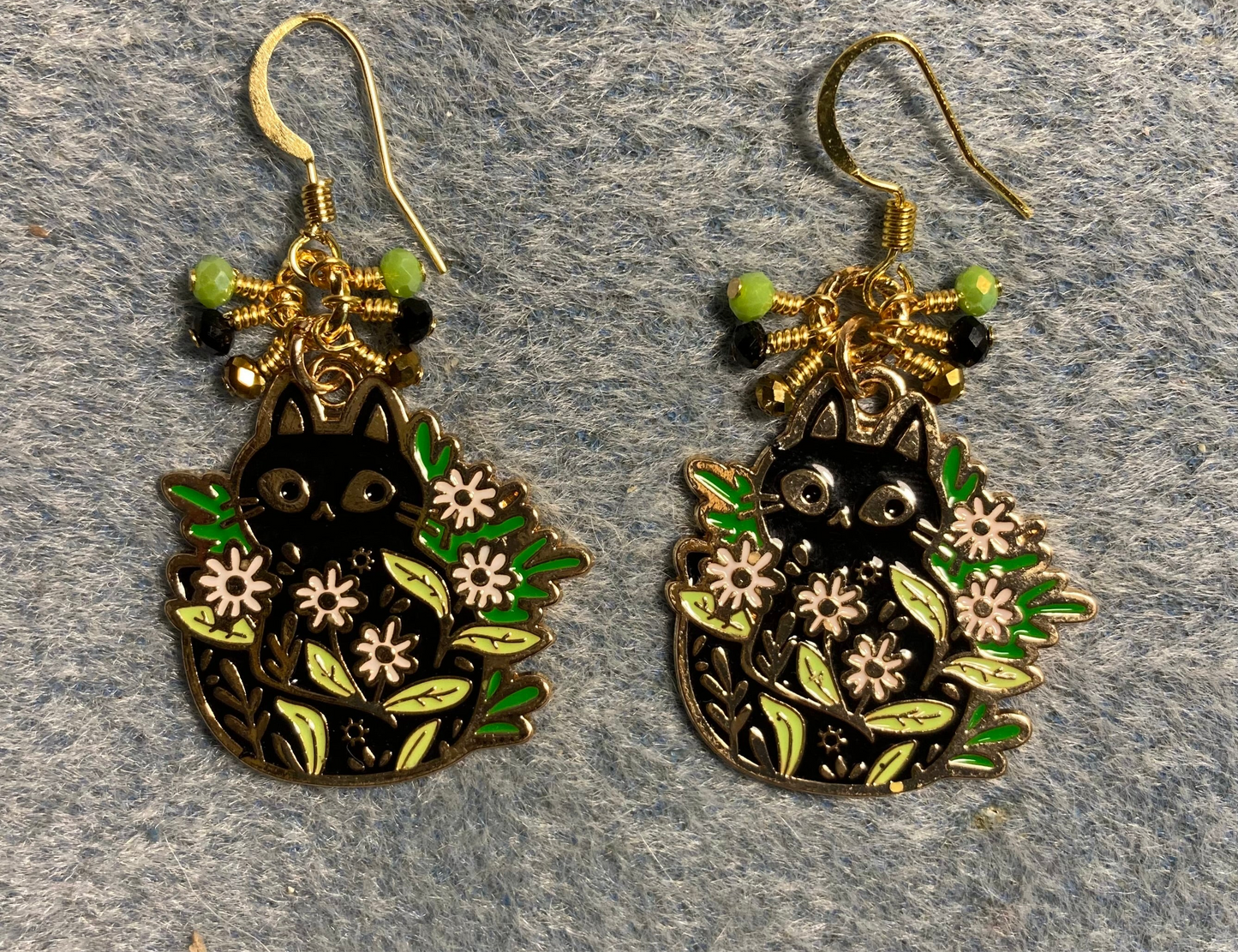 Black and green enamel cat charm earrings adorned with tiny dangling black, lime green, and dark green Chinese crystal beads.