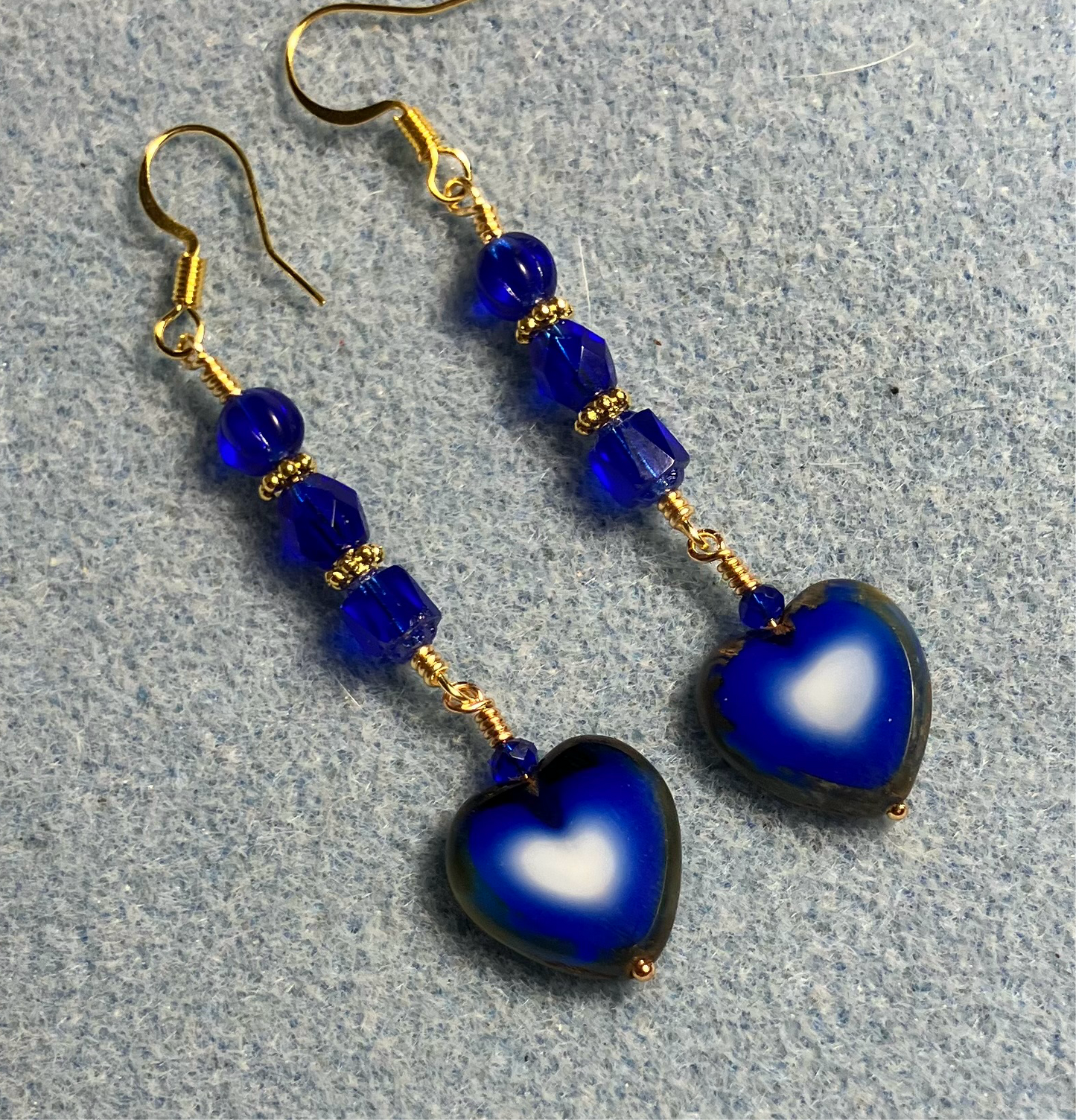 Dark blue Czech glass heart bead earrings adorned with dark blue Czech glass beads.