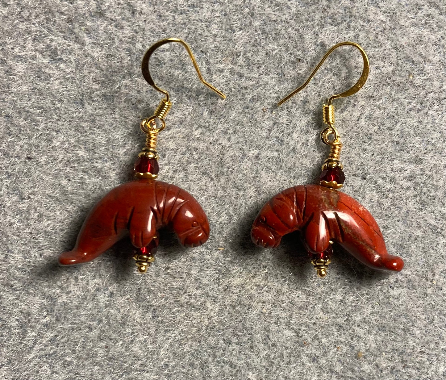 Red poppy jasper gemstone manatee bead earrings adorned with dark red Chinese crystal beads.