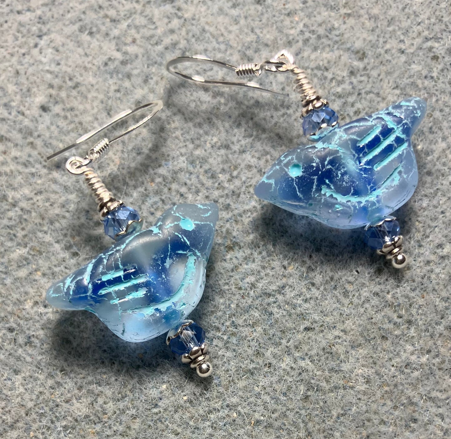 Light blue (with light blue wash) Czech glass bird bead earrings adorned with light blue Chinese crystal beads.
