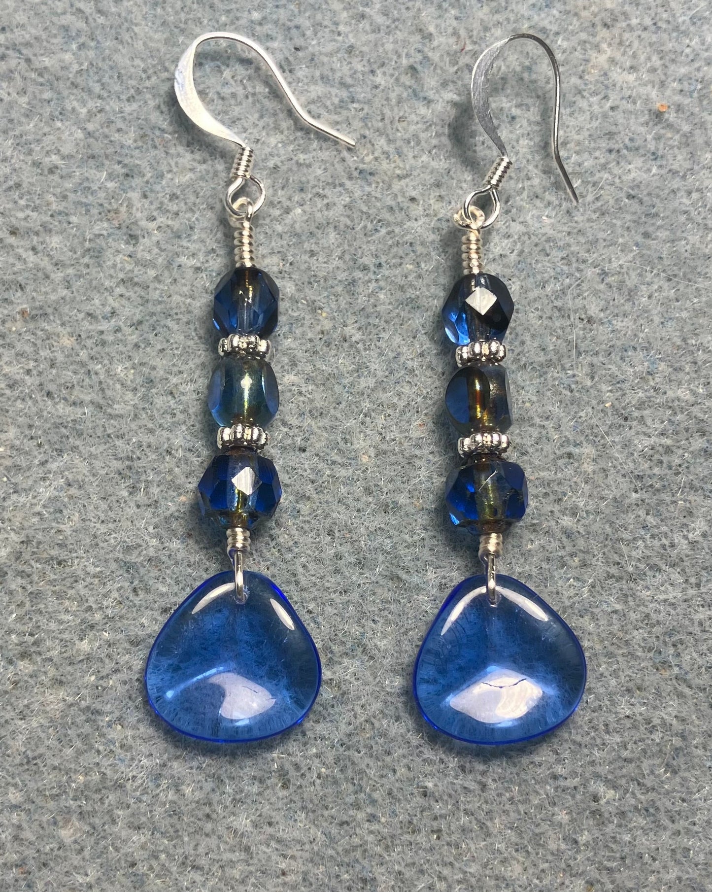 Translucent dark blue Czech glass rose petal earrings adorned with dark blue Czech glass beads.