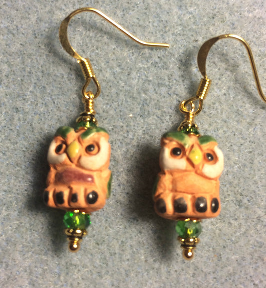 Small tan, green, and yellow ceramic owl bead earrings adorned with green Chinese crystal beads.