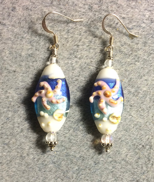 White, blue, and pink lamp work starfish bead earrings adorned with clear Czech glass beads.