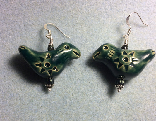 Large dark green ceramic songbird bead earrings adorned with dark green Czech glass beads.