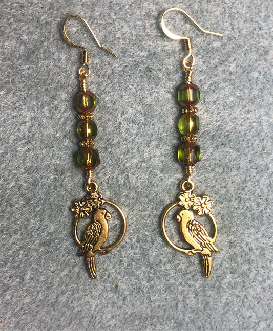 Gold parrot charm earrings adorned with olive green Czech glass beads