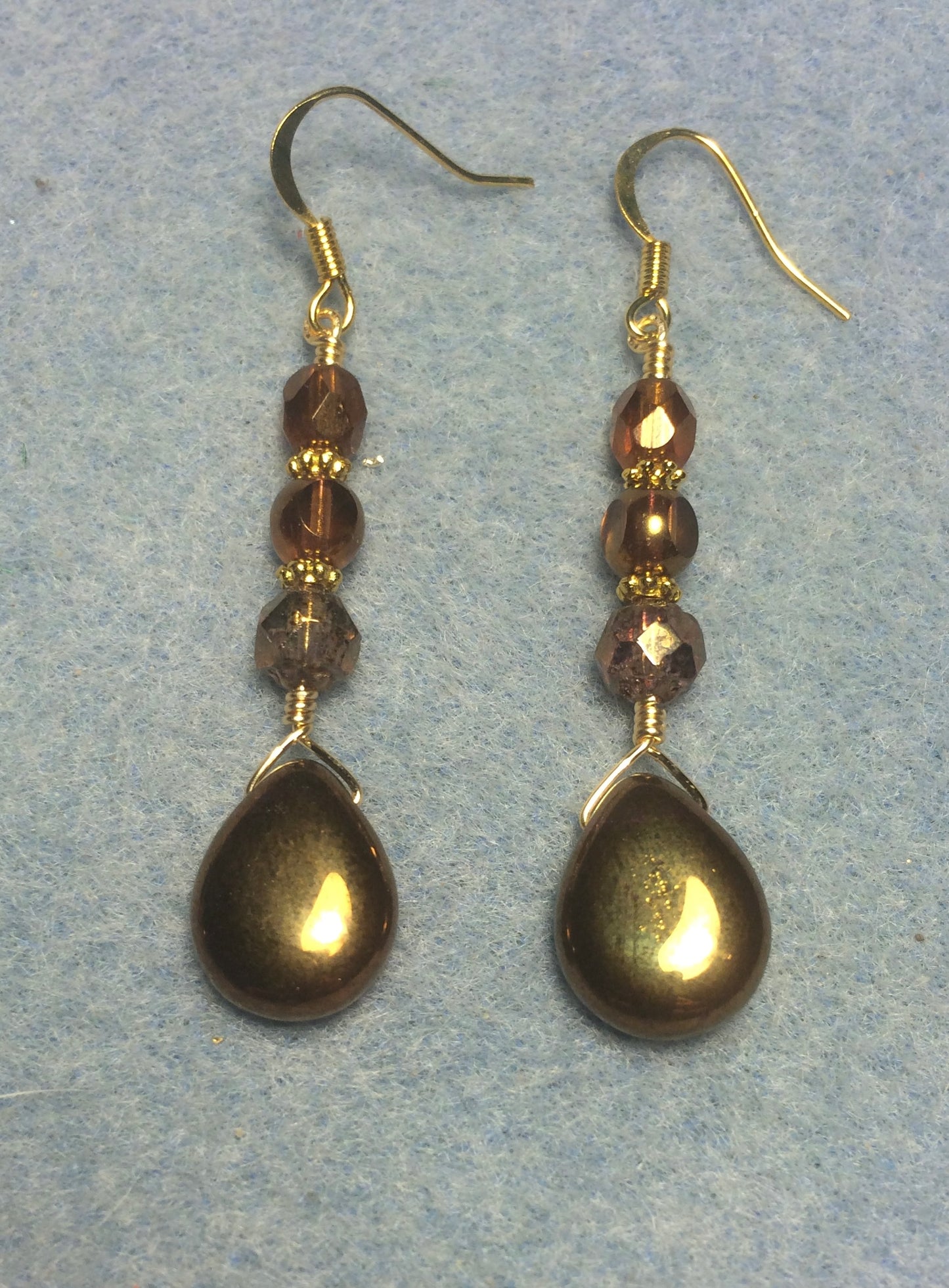 Shiny gold Czech glass pear drop bead earrings adorned with gold Czech glass beads.