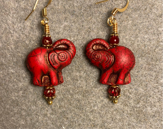 Red orange (with black gold inlay) Czech glass elephant bead earrings adorned with red orange Czech glass beads.