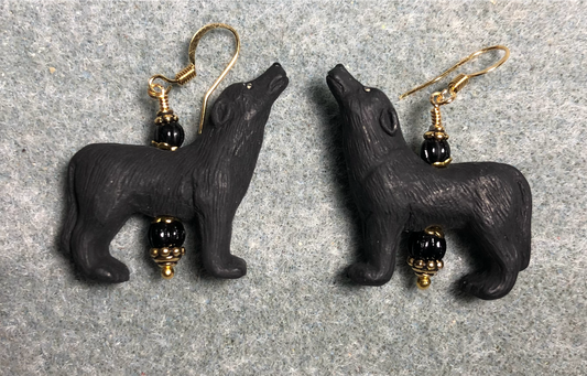 Black ceramic howling wolf bead earrings adorned with black Czech glass beads.