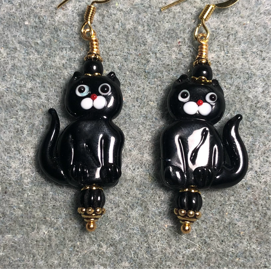 Opaque black lamp work cat bead earrings adorned with black Czech glass beads.