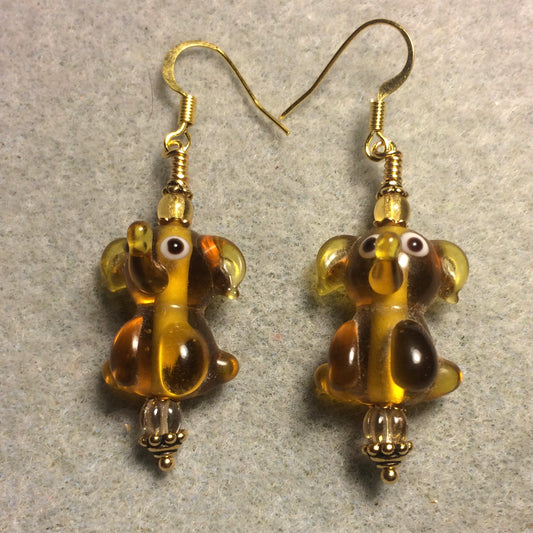Translucent amber lamp work sitting elephant bead earrings adorned with amber Czech glass beads.