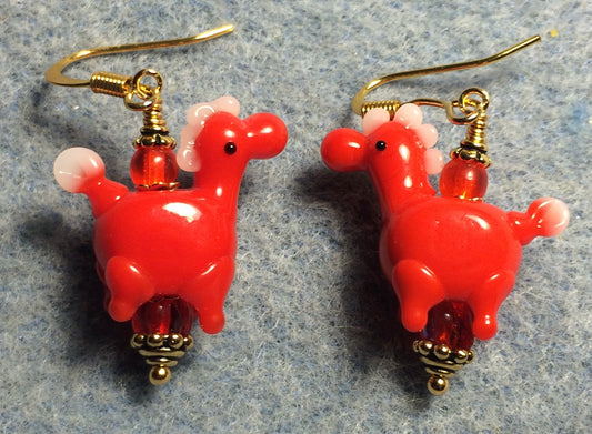 Opaque red lamp work horse bead earrings adorned with red Czech glass beads.