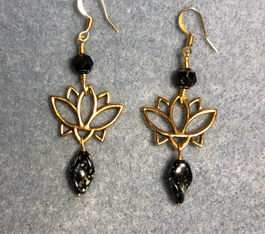 Gold lotus flower connector charm earrings adorned with black Picasso Czech glass twist beads and black Picasso Czech glass beads.