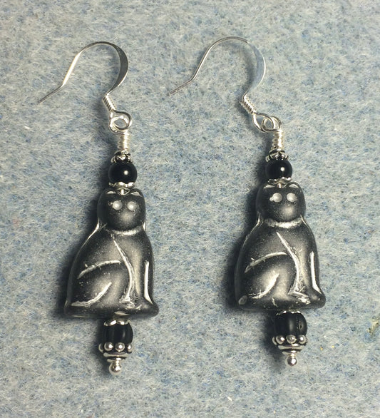 Matte black (with white inlay) Czech glass cat bead earrings adorned with black Czech glass beads.