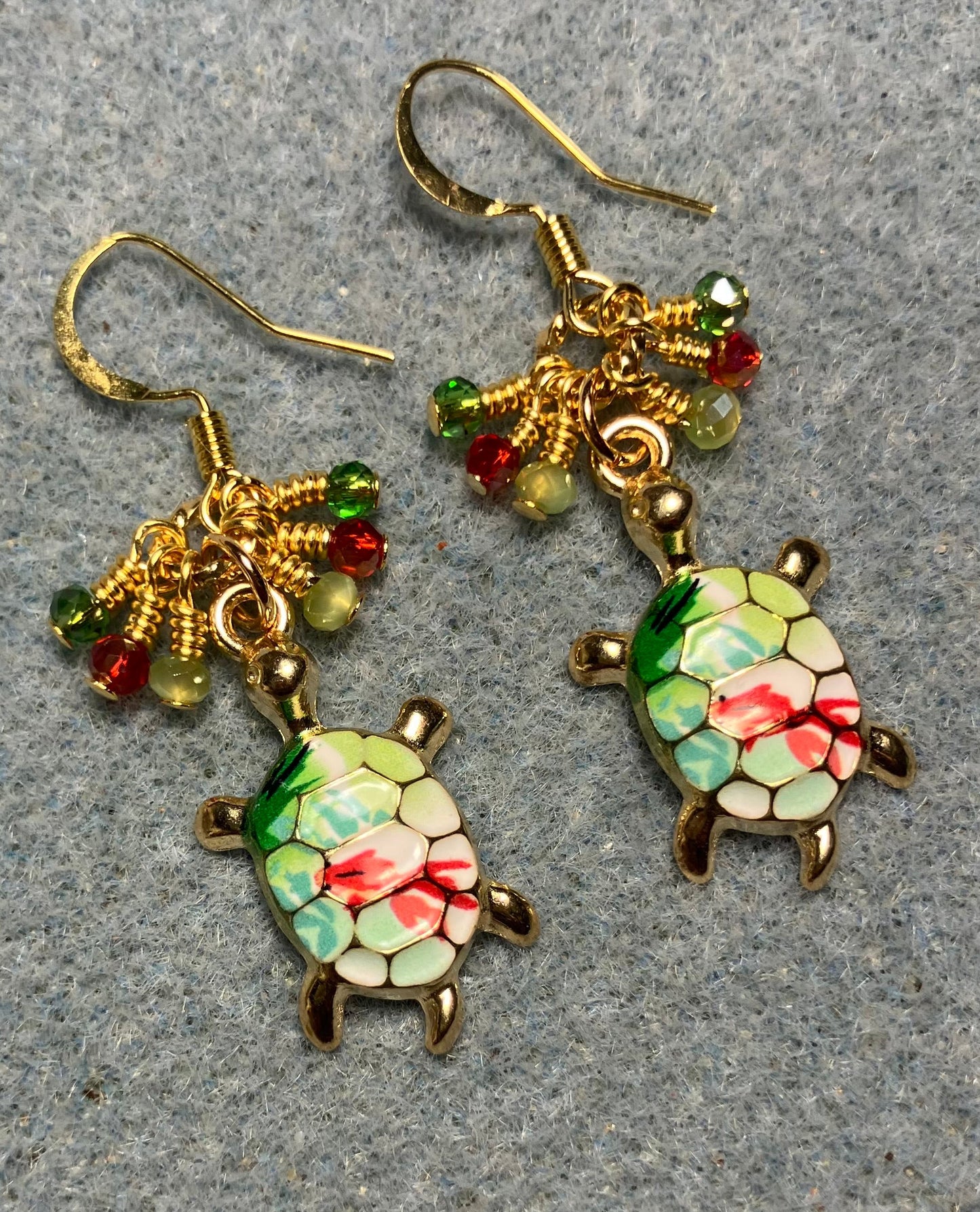 Green and red enamel turtle charm earrings adorned with tiny dangling dark green, red, and light green Chinese crystal beads.