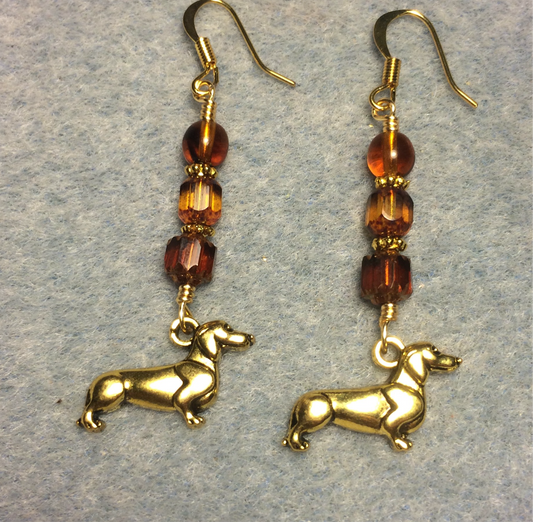 Gold dachshund charm earrings adorned with amber brown Czech glass beads
