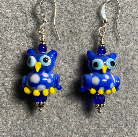 Black and yellow lamp work spotted owl bead earrings adorned with blue Czech glass beads.