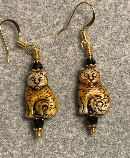 Medium tan and orange (with black inlay) Czech glass cat bead earrings adorned with black Chinese crystal beads.