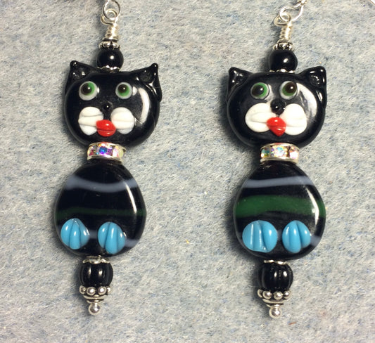 Black and aqua lamp work cat bead earrings adorned with clear rhinestone rondelle “collars” and black Czech glass beads.