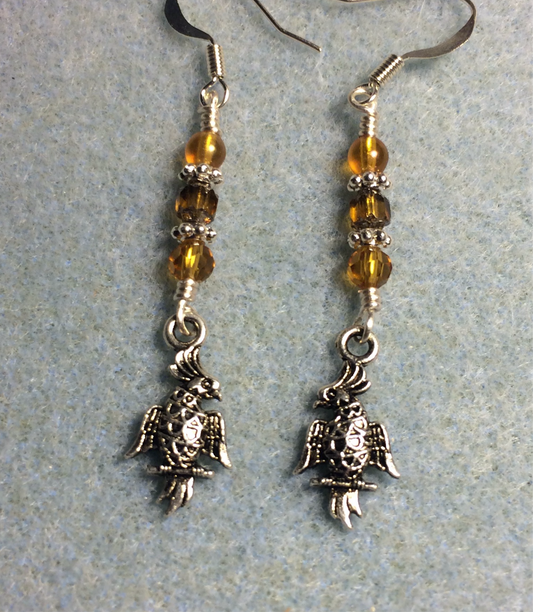 Small silver cockatoo charm earrings adorned with small amber Czech glass beads