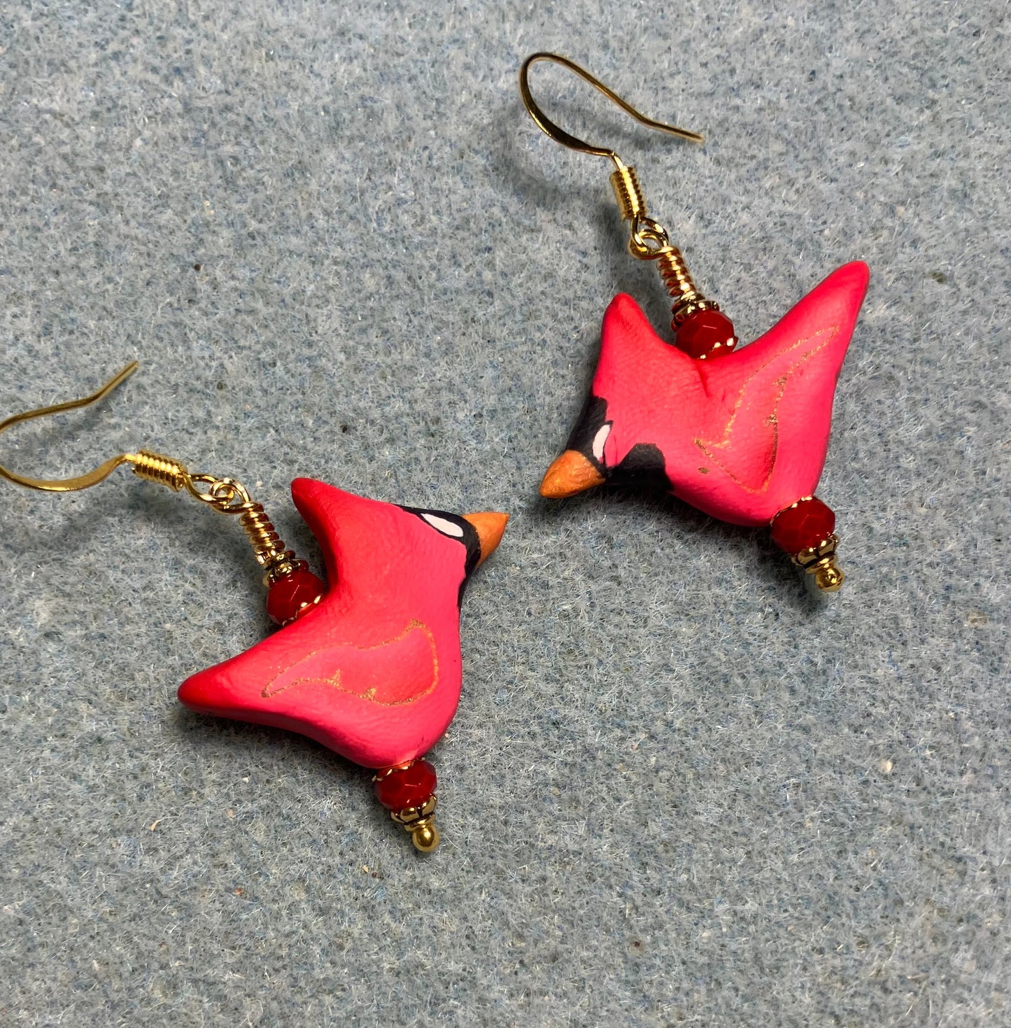Red polymer clay cardinal bead earrings adorned with red Chinese crystal beads.