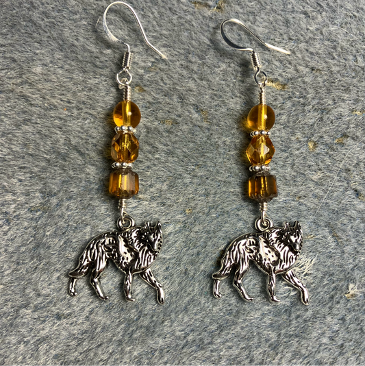 Silver walking coyote charm earrings adorned with amber Czech glass beads