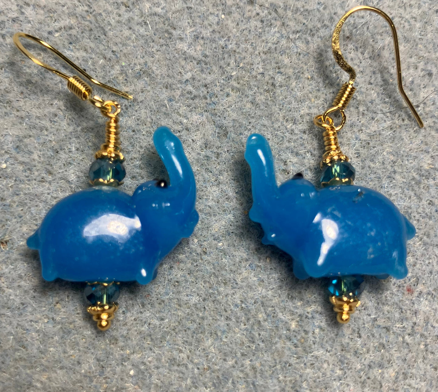 Small turquoise blue lamp work elephant bead earrings adorned with turquoise Chinese crystal beads.
