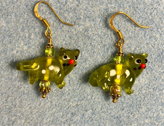 Translucent olive green lamp work spotted cat bead earrings adorned with olive green Czech glass beads.