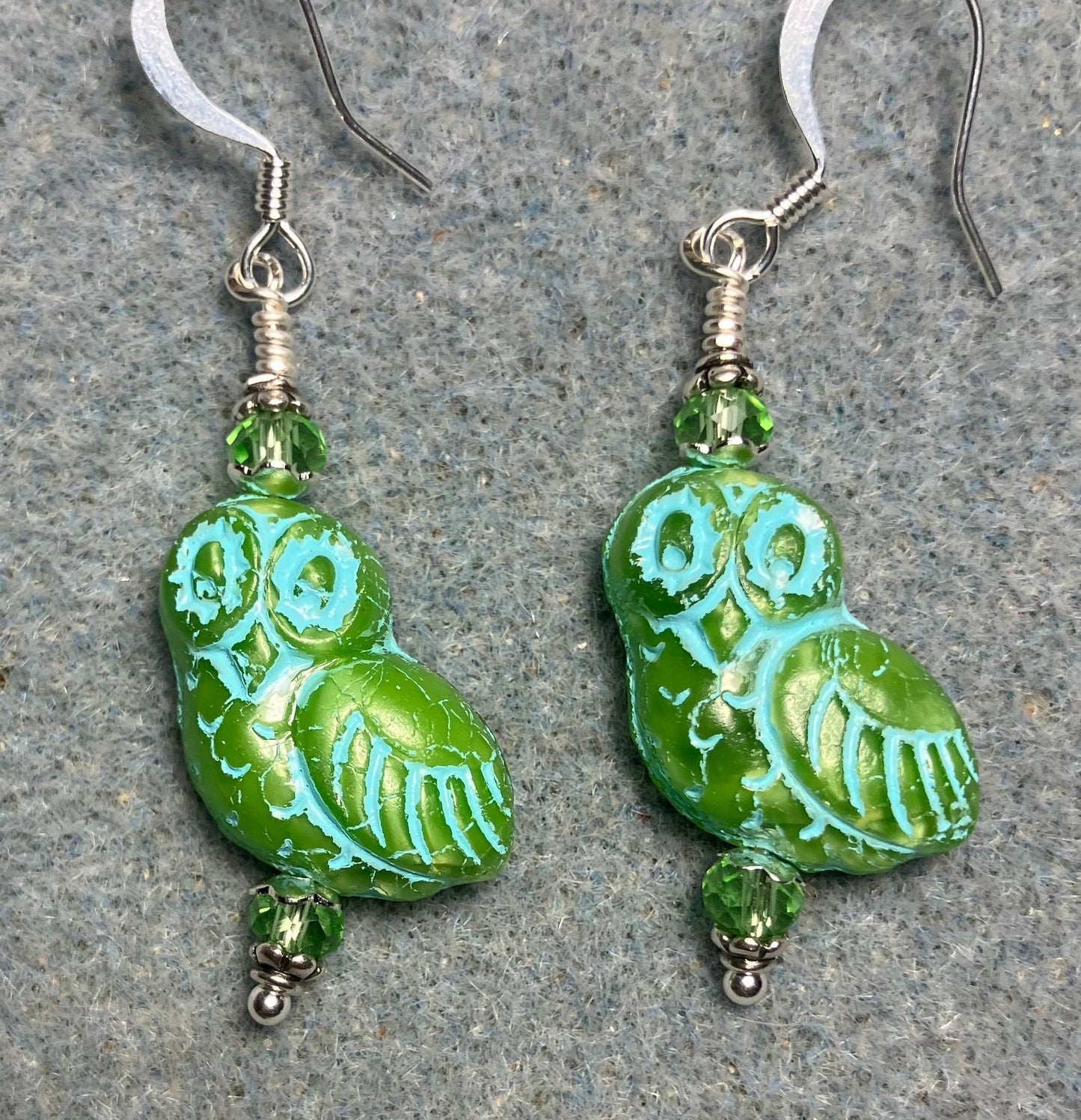 Light green (with turquoise inlay) fancy Czech glass owl bead earrings adorned with light green Chinese crystal beads.