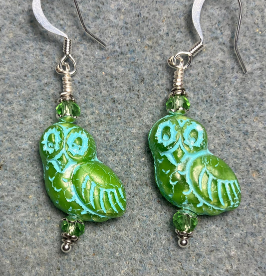 Light green (with turquoise inlay) fancy Czech glass owl bead earrings adorned with light green Chinese crystal beads.