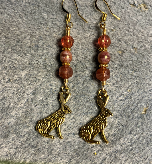 Gold rabbit charm earrings adorned with milky pink Czech glass beads