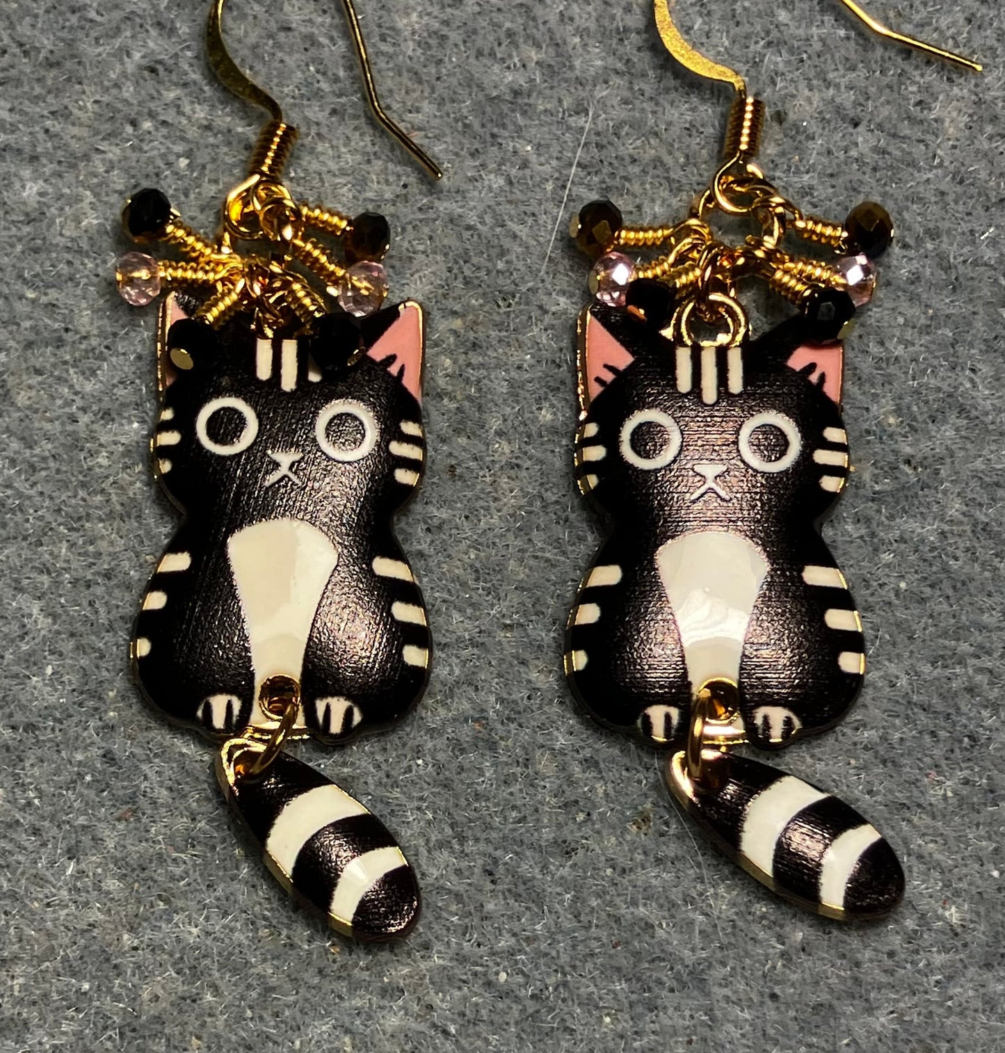 Black, white, and pink enamel cat charm earrings adorned with tiny dangling black, white, and pink Chinese crystal beads.