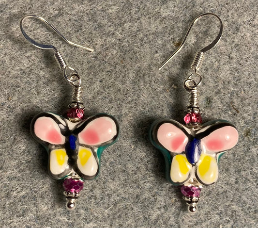 Pink, yellow, and green ceramic butterfly bead earrings adorned with hot pink Chinese crystal beads.