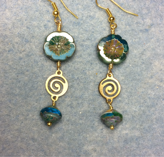 Teal turquoise Czech glass pansy bead earrings adorned with gold swirly connectors and turquoise Czech glass Saturn beads.