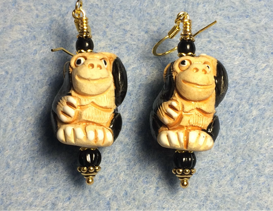 Large tan and black ceramic chimpanzee bead earrings adorned with black Czech glass beads.