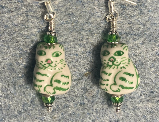 Green and white ceramic tabby bead earrings adorned with green Chinese crystal beads.