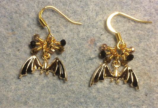 Black and gold enamel bat charm earrings adorned with tiny dangling black and gold Chinese crystal beads.