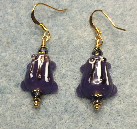 Purple with black stripes lamp work frog bead earrings adorned with purple Chinese crystal beads.