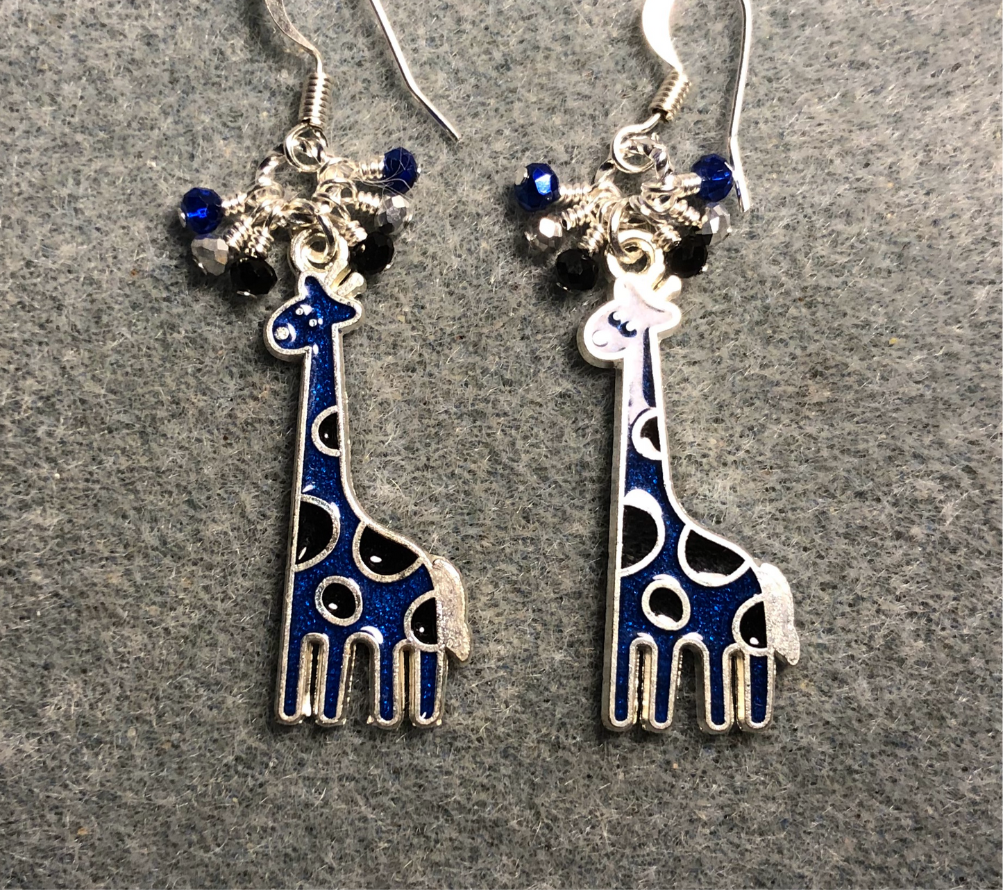 Dark blue and black enamel spotted giraffe charm earrings adorned with tiny dangling dark blue, silver, and black Chinese crystal beads.