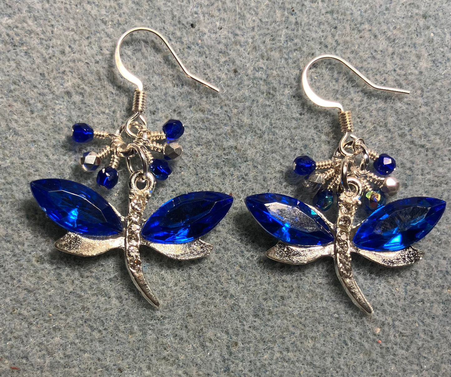 Dark blue and silver rhinestone dragonfly charm earrings adorned with small dangling dark blue and silver Czech glass beads.