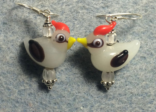Milky white and red lamp work songbird bead earrings adorned with matte clear Czech glass beads.