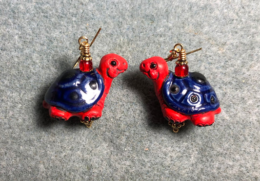 Large red and dark blue ceramic turtle bead earrings adorned with red Czech glass beads.