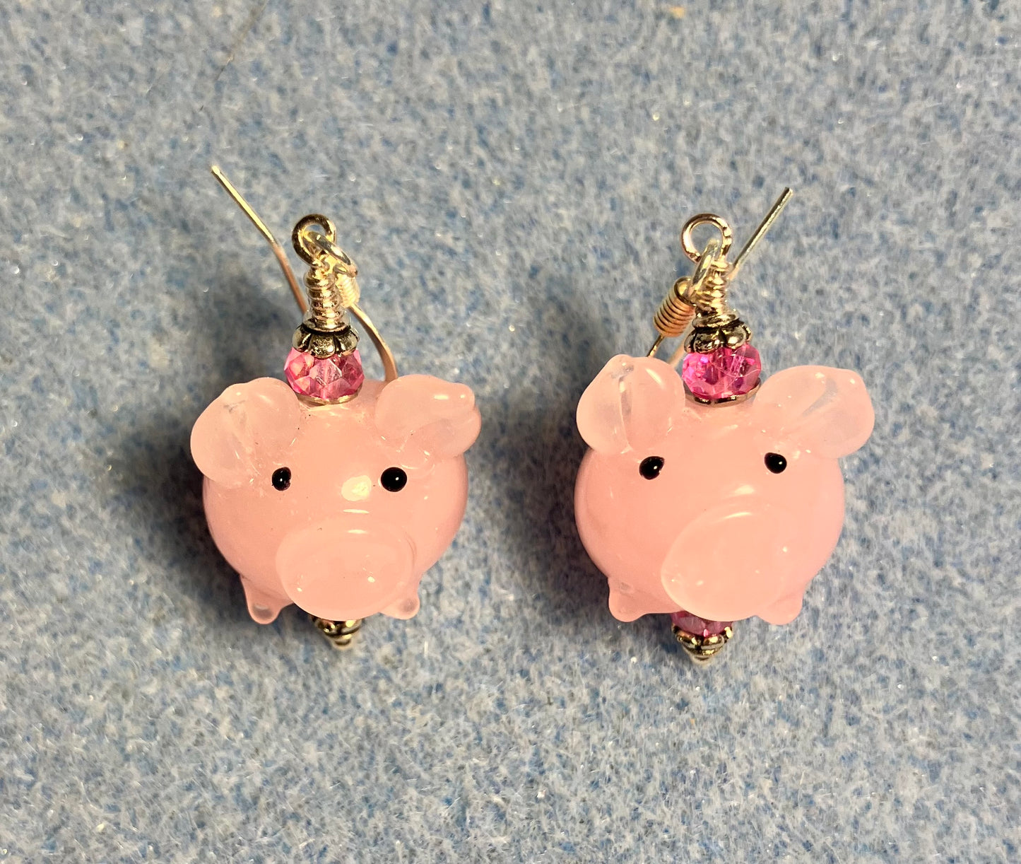 Small light pink lamp work pig bead earrings adorned with hot pink Chinese crystal beads.