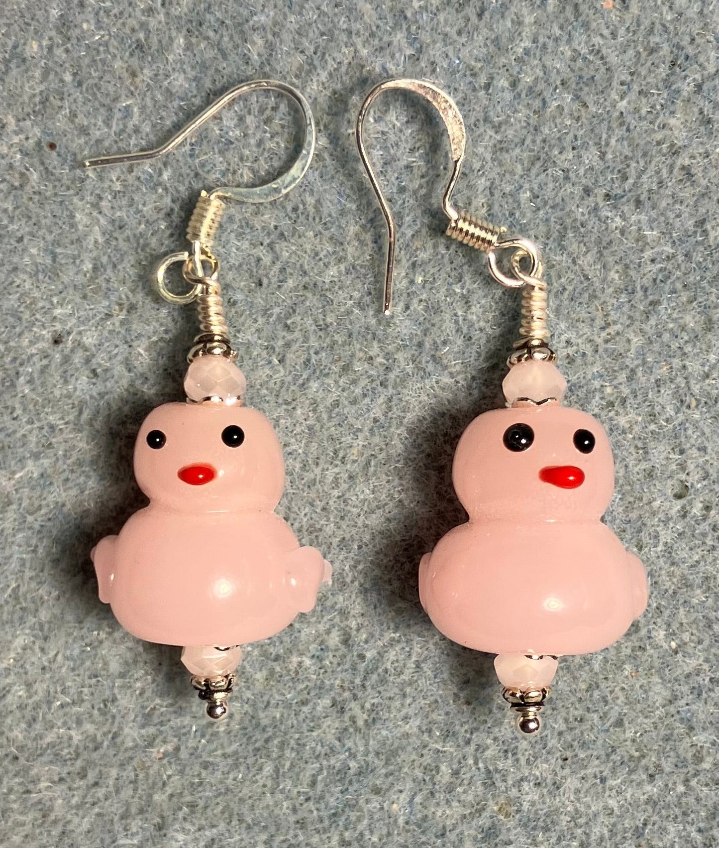 Opaque pink lamp work duck bead earrings adorned with pink Chinese crystal beads.