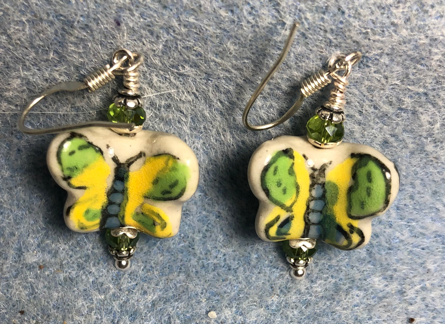 Green and yellow ceramic butterfly bead earrings adorned with green Chinese crystal beads.