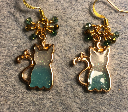 Teal and gold sparkly resin cat charm earrings adorned with small dangling teal and gold Chinese crystal beads.
