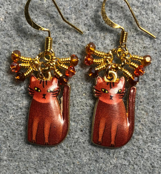 Brown, amber, and orange enamel cat charm earrings adorned with tiny dangling brown, amber, and orange Chinese crystal beads.