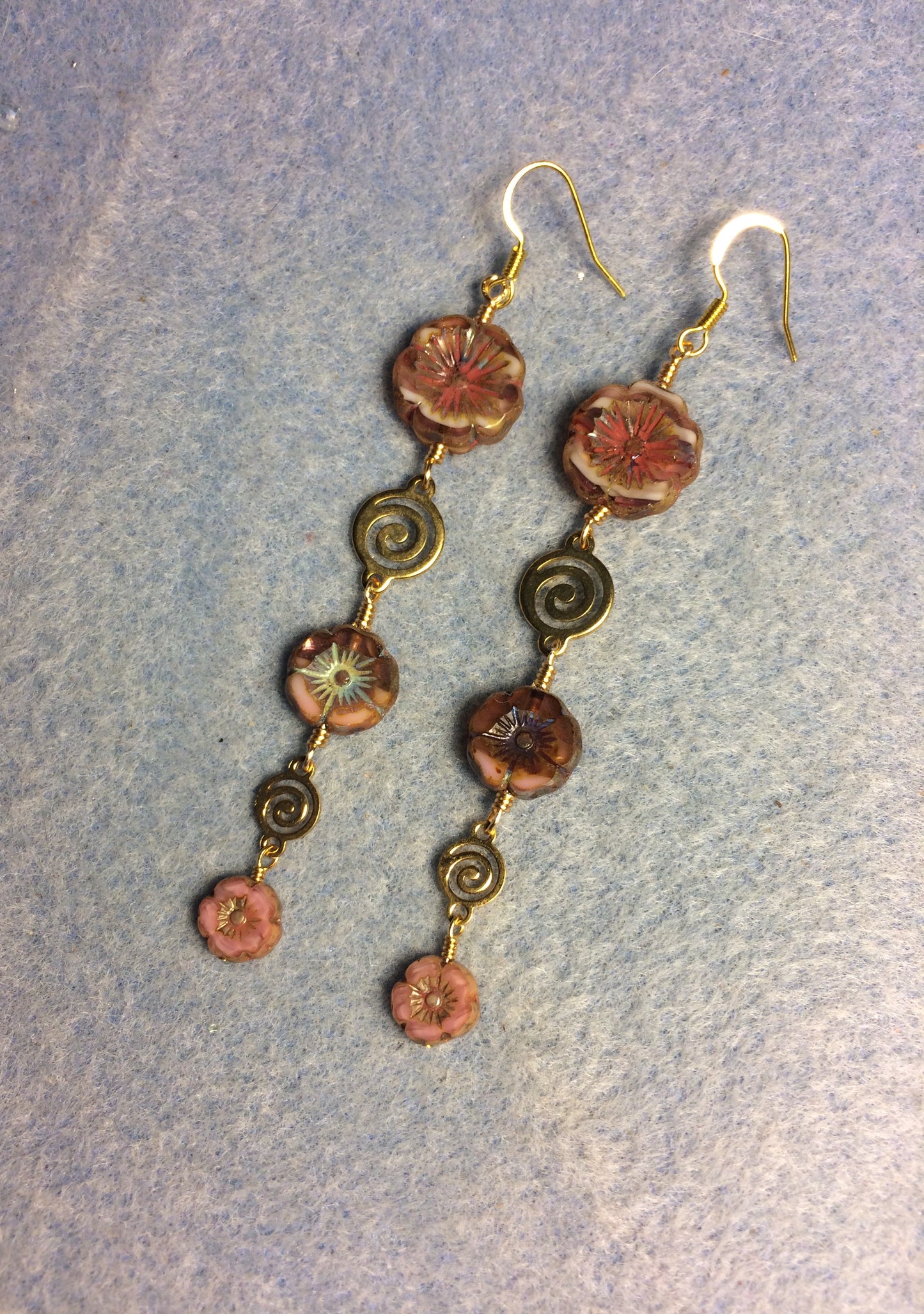 Extra long pink flower bead earrings made with three sizes of pink and white swirl Czech glass pansy beads joined by gold swirly connectors.