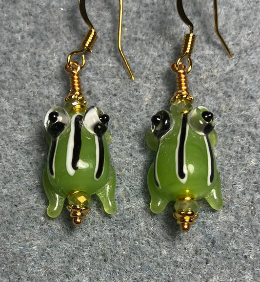 Very small opaque olive green with black and white stripes lamp work frog bead earrings adorned with olive green Chinese crystal beads.