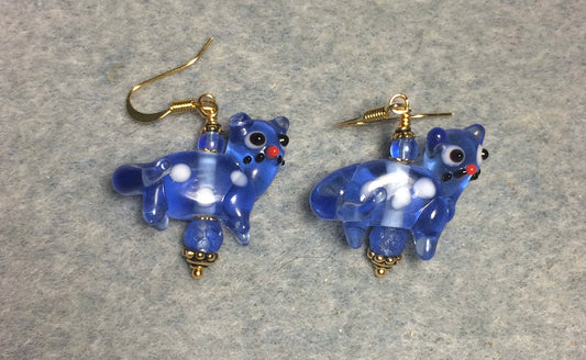 Translucent blue lamp work spotted cat bead earrings adorned with blue Czech glass beads.